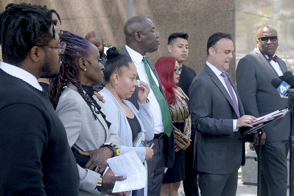 Elizabeth Aguirre Arenas wipes a tear as attorney Adam Slater speaks during a press conference in Los Angeles in June 2022, accompanied by people who were part of a lawsuit alleging abuse at MacLaren Children's Center, a foster-care facility. 